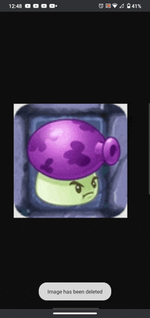 a screenshot of a purple mushroom from plants vs zombies on a cell phone