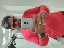 a man taking a picture of himself in the mirror