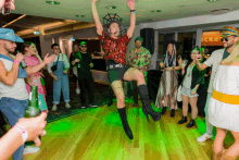 a group of people are dancing in front of a sign that says tickets