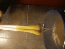 a person is pouring liquid into a bucket