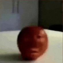 a close up of a red ball with a face on it .