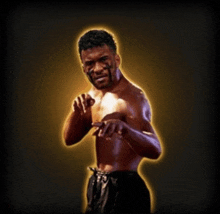 a boxer without a shirt is standing in front of a black background