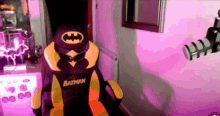 a yellow and purple batman chair with a bat on it