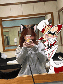 a girl with cat ears takes a selfie with a cartoon character in the mirror