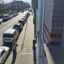 a row of cars are parked on the side of the road next to a parking meter