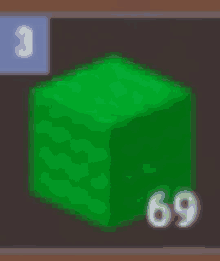 a green cube with the number 69 on it is sitting on a table .