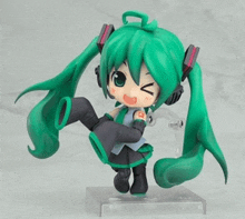 a figurine of hatsune miku with headphones on her head