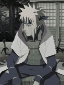 a man with blonde hair and a headband that says ' naruto ' on it sits on the floor