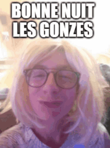 a woman wearing glasses and a blonde wig has the words bonne nuit les gonzes above her