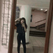 a girl is taking a picture of herself in a mirror