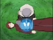 a couple of anime characters laying on top of each other on a lush green field .