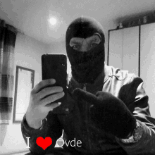 a man in a ski mask takes a selfie with the words i love ovde