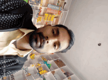 a man standing in front of a shelf with a toothbrush on it that says ' dental ' on it