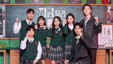 a group of students posing for a picture in front of a blackboard with chinese writing