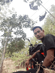 a man sits on a motorcycle in a field