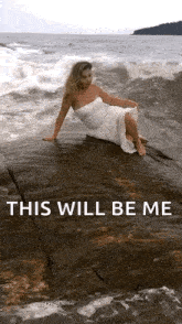 a woman in a white dress is sitting on a rock near the ocean with the words " this will be me " below her