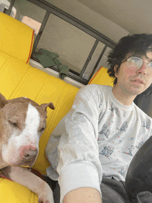 a man and a dog are sitting in the back seat of a vehicle