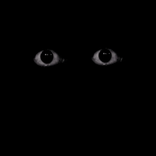 a close up of a person 's eyes glowing in the dark .