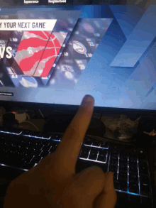 a person 's finger is pointing at a screen that says ' your next game '