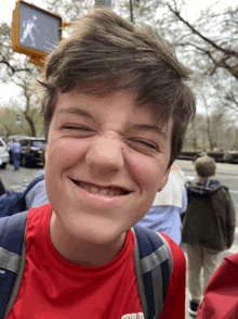 a young boy wearing a red shirt that says ' columbia ' on it