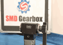 a smd gearbox is sitting in front of a sign