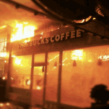 a starbucks coffee store is burning in flames