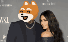 a woman stands next to a man with a doge face on his head