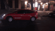 a red car with radar speed written on the side of it