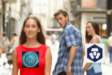 a man and a woman are walking down a street with a picture of a circle on the woman 's shirt