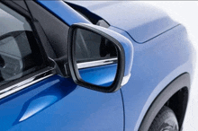 a close up of a blue car side mirror