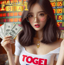 a woman wearing glasses and a white shirt that says ' togel '