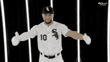 a baseball player wearing a white sox jersey with the number 10 on it