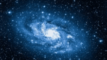 a blue and white spiral galaxy in the middle of a galaxy filled with stars .