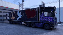 a purple and blue truck with graffiti on the side says roy