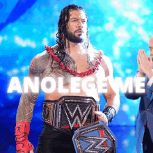 a wrestler holding a wrestling belt with the words anolegeme behind him