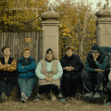 a group of people sitting in front of a fence with la guarimba film festival written on the bottom left