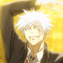 a man with white hair is wearing a suit and tie and making a heart shape with his hands .