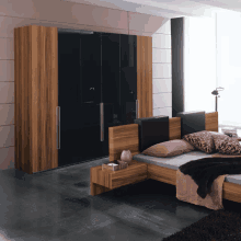 a bedroom with a bed and a wardrobe with a black door