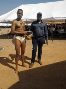 a man in a diaper is standing next to another man