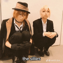 a couple of people sitting next to each other with the words " the sillies " on the bottom