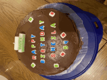 a birthday cake for sheila sits on a blue plate