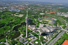 an aerial view of a city with a tower in the middle of it