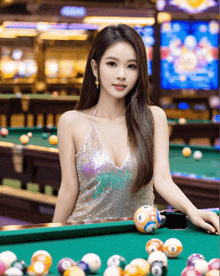 a woman in a sequined dress is standing next to a pool table