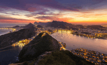 a large body of water surrounded by mountains and buildings