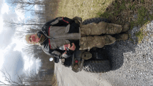 a man standing next to a four wheeler holding a bottle of soda