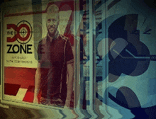 a picture of a man in front of a sign that says the zone