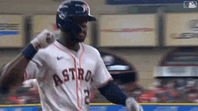 a baseball player wearing a helmet and a jersey with the word astros on it is standing on the field .