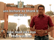 a man in a red shirt stands in front of a sign that says india