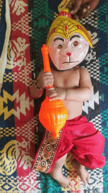 a child wearing a monkey mask is holding a toy