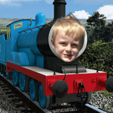 a blue train with a boy 's face on the front